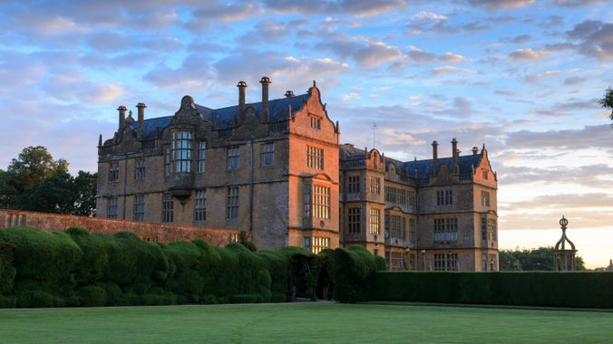 View of the east side of Montacute House from Cedar Lawn with sunshine hitting the house